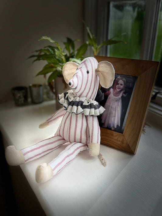 Stuffed toy animal with striped body.